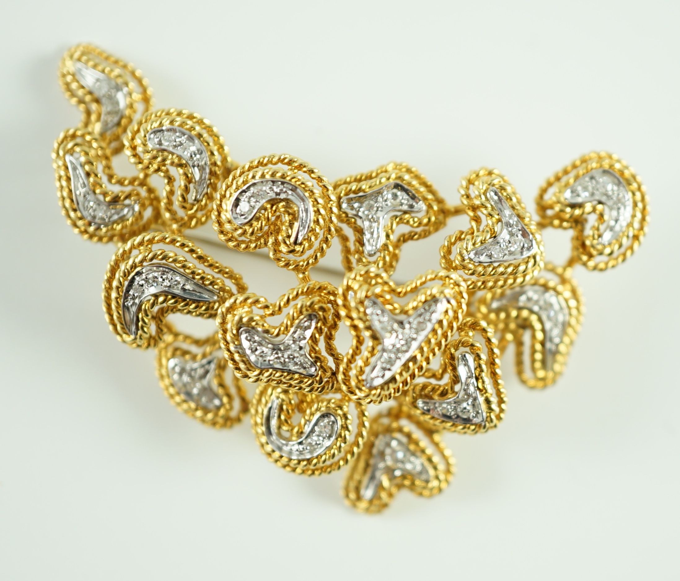 A modern stylish Italian 750 gold and diamond chip set modernist brooch